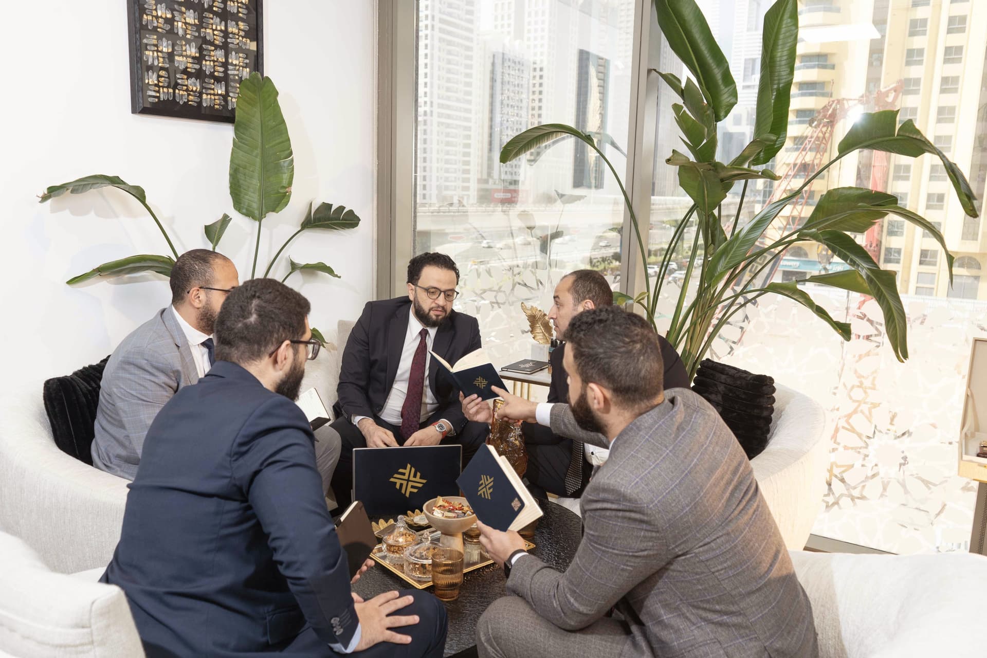 Advisors in discussion with the Dubai skyline behind them